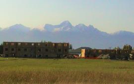partially build home with hazy mountain range in the background