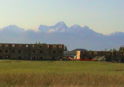 partially build home with hazy mountain range in the background
