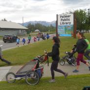3 moms with strollers participating in fun run in front of the library