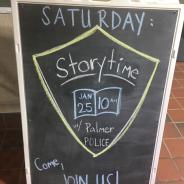 A chalkboard with a drawing of a shield with a book inside, "Saturday: Storytime Jan 25 10 AM w/ Palmer Police" "Come, Join Us!"