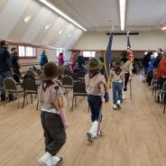 Boy scouts carrying the Alaska and American flag