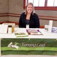 A woman at the Turning Leaf Literacy Center table