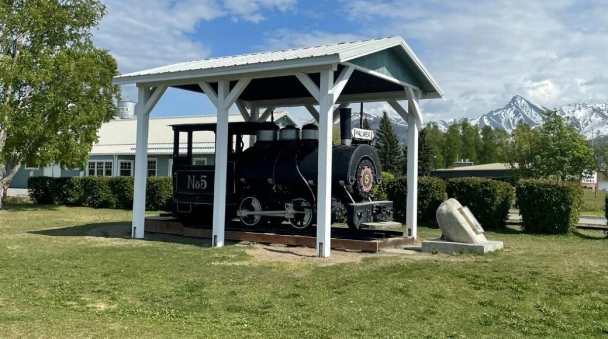 Train engine in front of old train depot