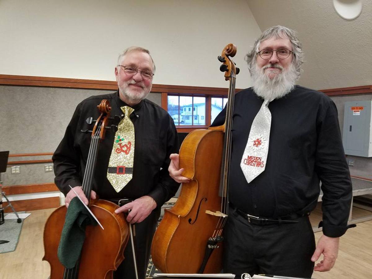 Two cello players wearing Christmas ties