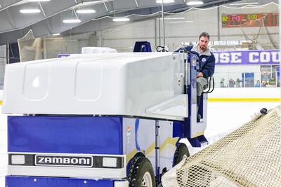employee on ice resurfacer